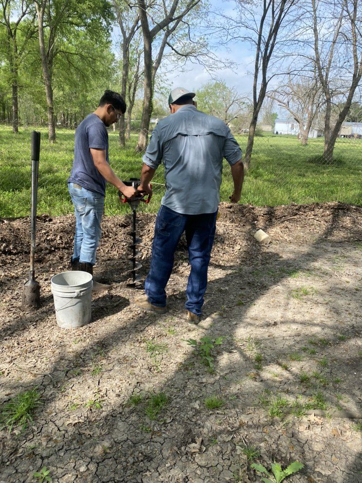 Penaloza Broz crew boring post holes with a power auger on a rural property near Navasota, TX