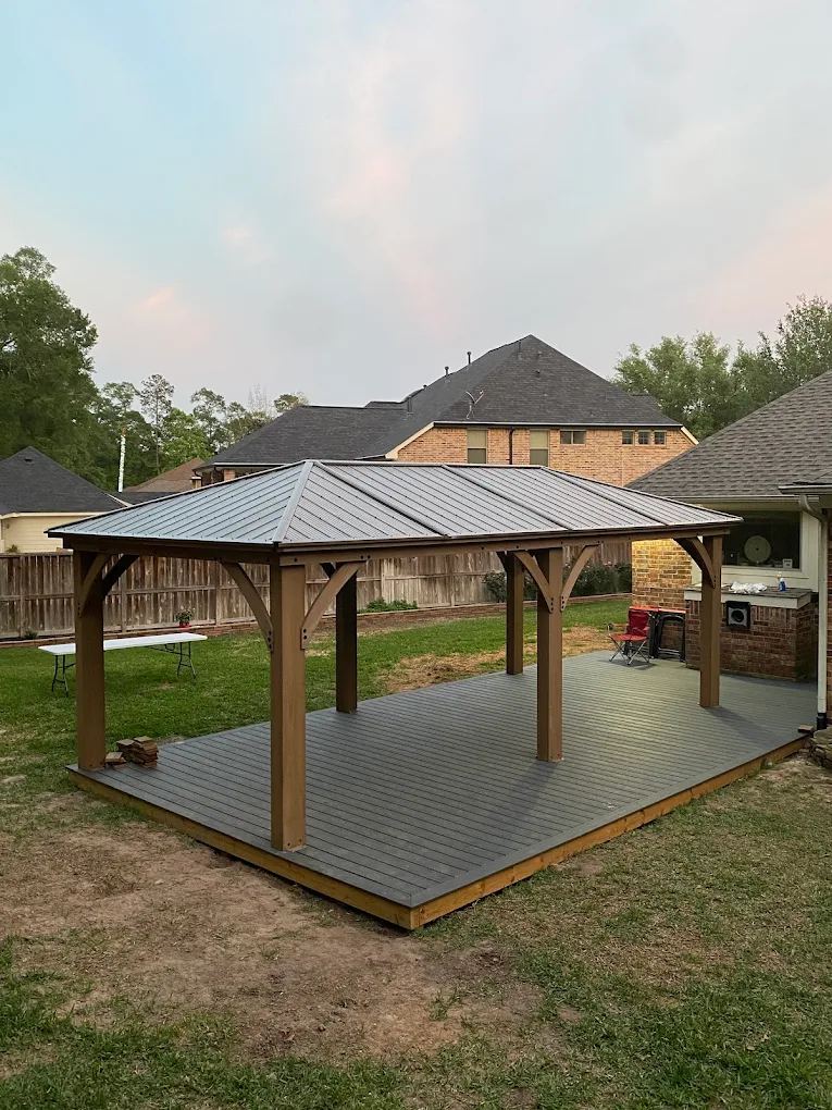 Backyard pavilion with a metal hardtop roof built on a new composite deck