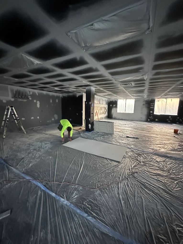 Large interior build-out with floated walls, open ceiling grid and drywall being set